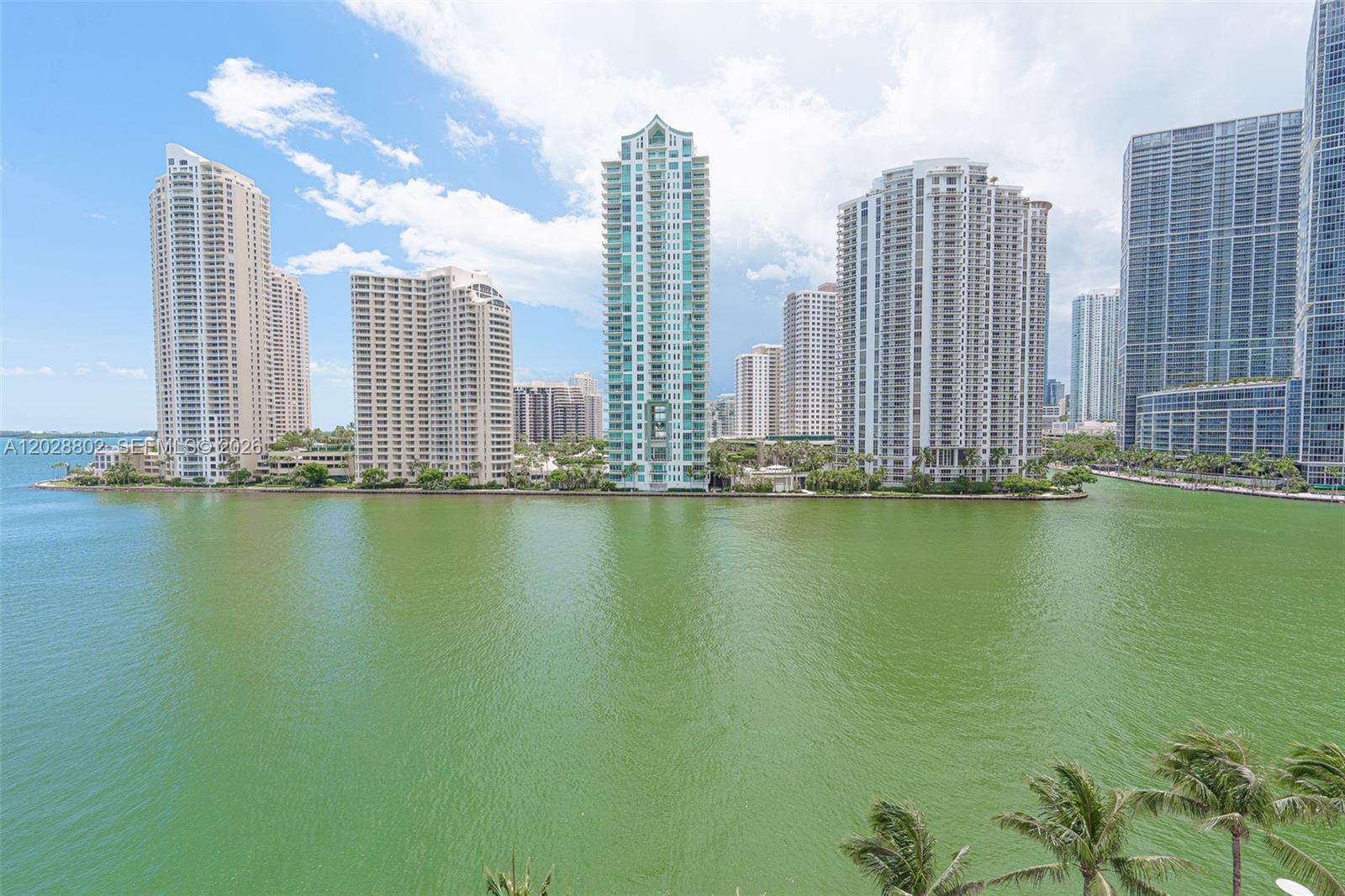 A view of high-rise residential buildings situated along a waterfront under a cloudy sky — 325 S Biscayne Blvd # 821, Miami FL 33131, MIAMI, FL