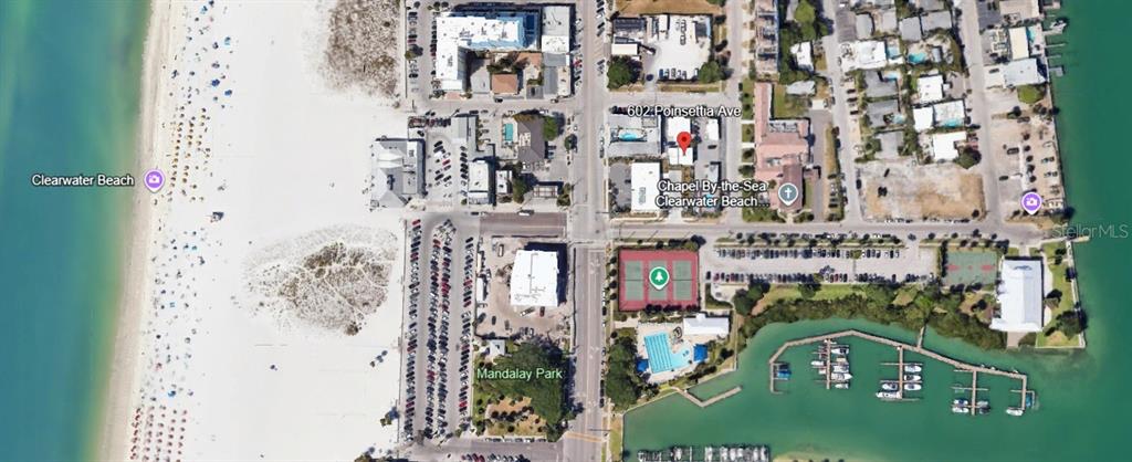 This is an aerial map view of a coastal area featuring a beach, park, and marina — 602 POINSETTIA AVENUE, CLEARWATER BEACH, FL