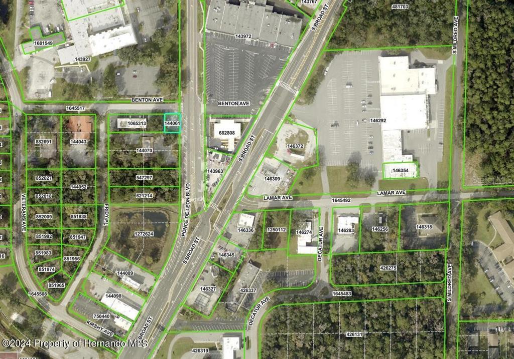 This is an aerial map showing property parcels, streets, and buildings in a neighborhood — 705 BENTON AVENUE, BROOKSVILLE, FL