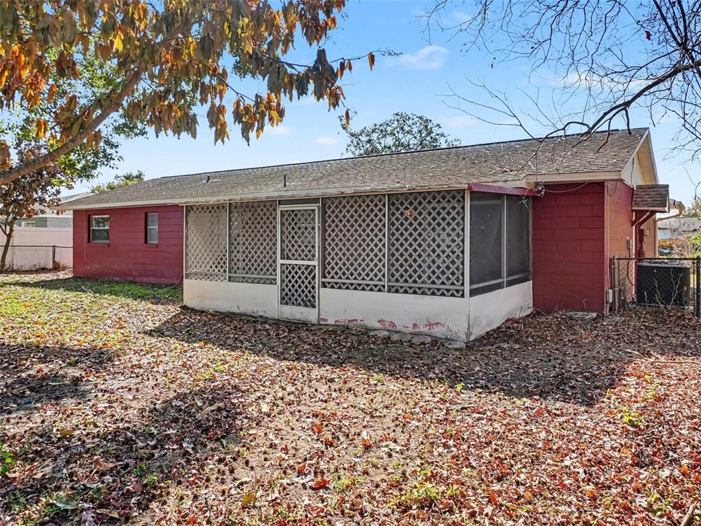 The exterior of a red brick house features a screened-in porch with lattice panels — 555 THOMAS JEFFERSON WAY, ORLANDO, FL