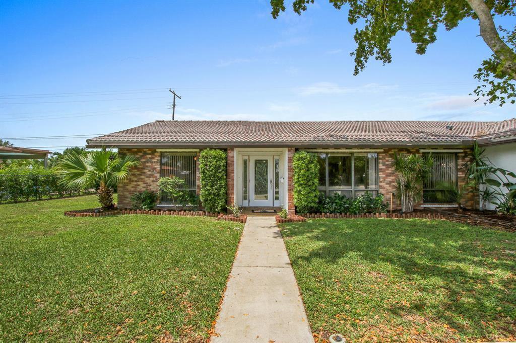 A single-story brick house with a tiled roof, a front walkway, and surrounding landscaping — 1501 NW 7th Street, Boca Raton FL 33486, BOCA RATON, FL