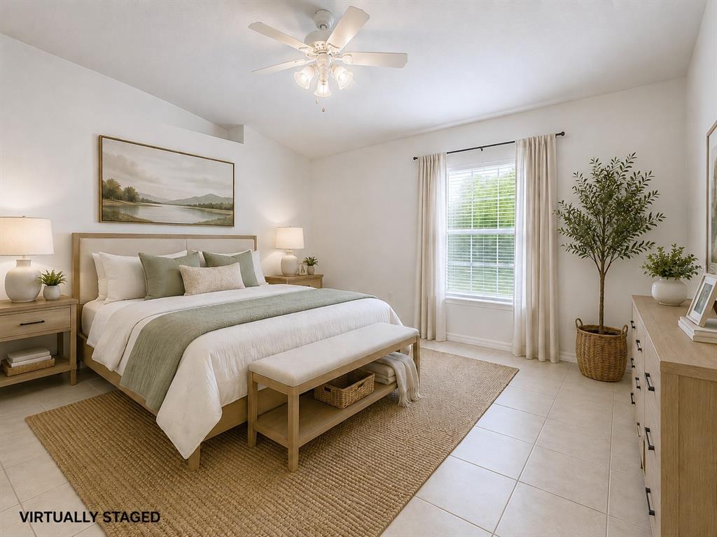 A virtually staged bedroom features a bed, nightstands, a bench, and a window with curtains — 10155 LAXTON STREET, ORLANDO, FL