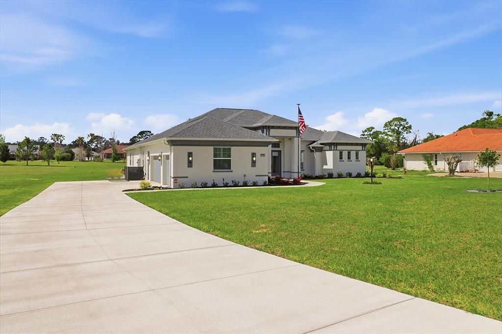 A single-story house with a concrete driveway and a large green lawn — 418 N CHERRY POP DRIVE, INVERNESS, FL