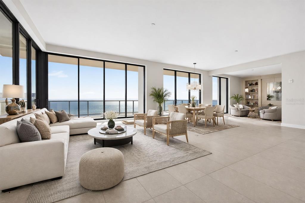 A spacious, open-concept living and dining area features floor-to-ceiling windows with ocean views — 275 1ST AVENUE S UNIT 4202, ST PETERSBURG, FL