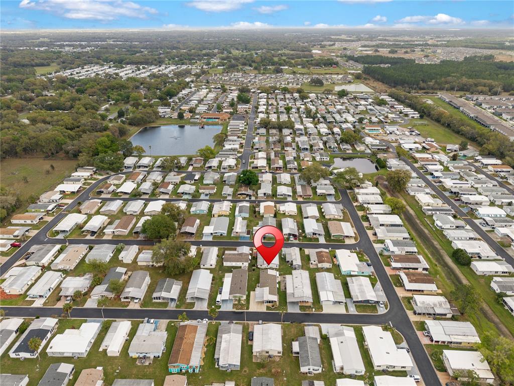 This is an aerial view of a residential mobile home park with a red location pin — 3120 POND HOLLOW STREET, WESLEY CHAPEL, FL