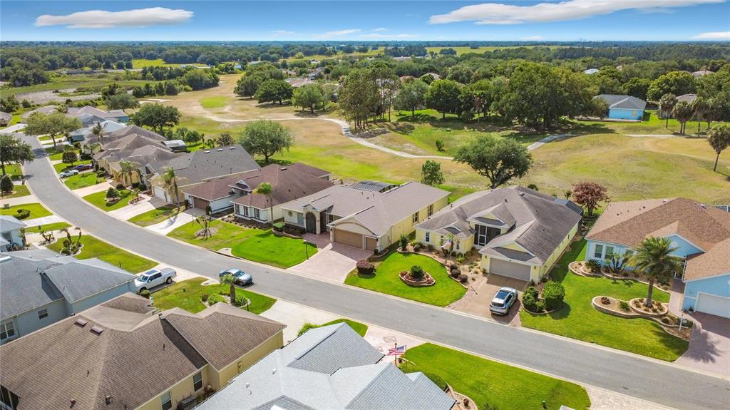An aerial view of a suburban street with single-family homes bordering a golf course — 4810 SABLE RIDGE COURT, LEESBURG, FL