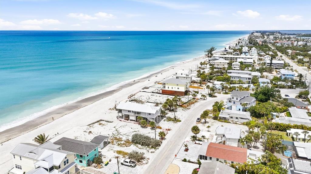 An aerial view shows beach houses along a coastline with a sandy beach and ocean — 1210 SHORE VIEW DRIVE UNIT B, ENGLEWOOD, FL
