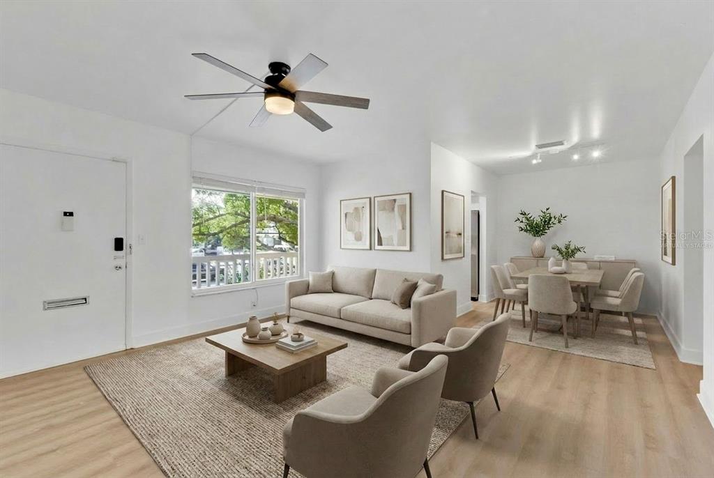 A living and dining area with light wood floors, a ceiling fan, and neutral furniture — 1140 S ORLANDO AVENUE UNIT I14, MAITLAND, FL