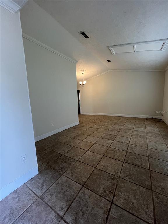 An interior view of a room with vaulted ceilings, tiled floors, and a chandelier — 3222 HAMMERSMITH ROAD, ORLANDO, FL