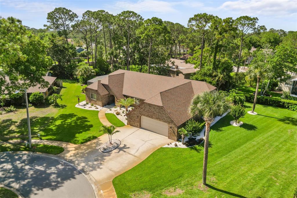 An aerial view of a single-story brick house with a brown roof and attached garage — 112 PEACHTREE CIRCLE, DAYTONA BEACH, FL