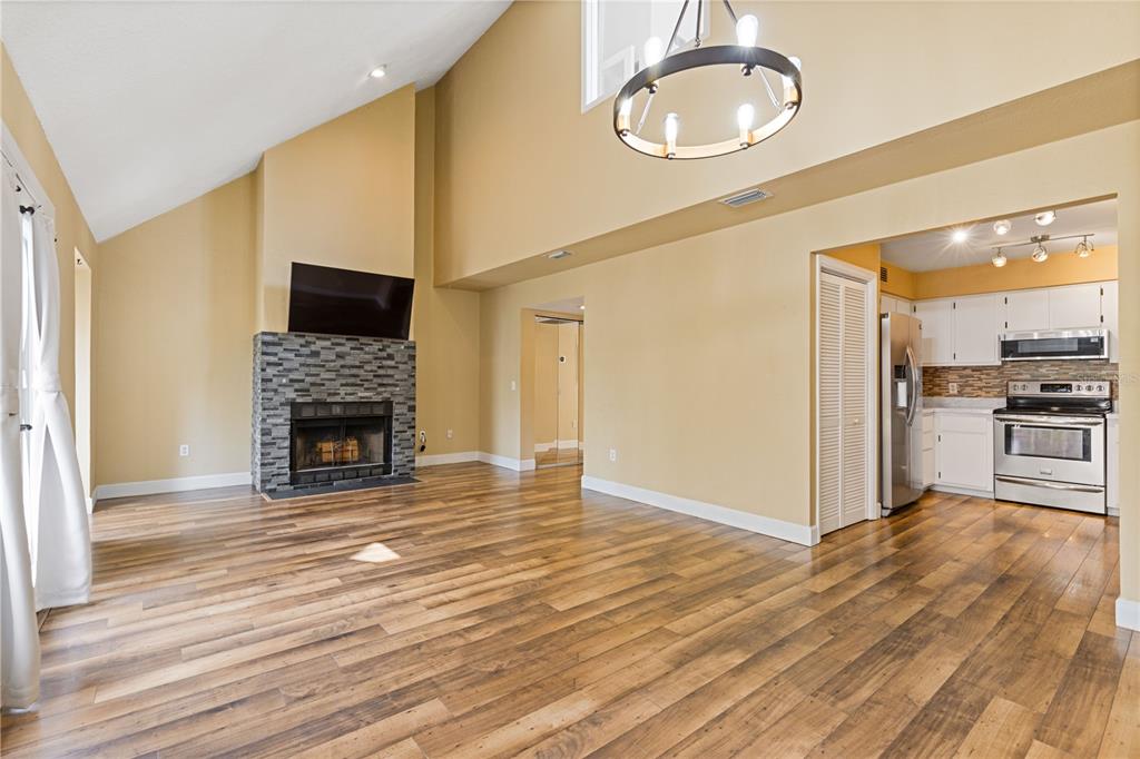 An entryway features wood-look flooring, a coat rack with a bench, and a glass-paneled door — 1621 NE 2ND STREET UNIT 302, OCALA, FL