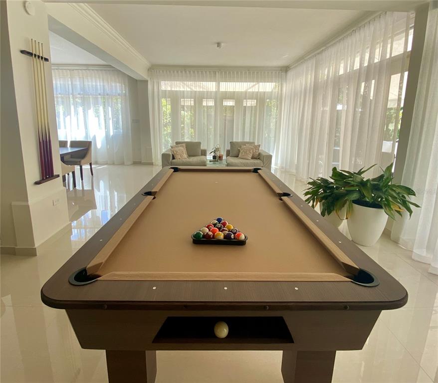 A billiards table sits in a bright room with white tile floors and floor-to-ceiling curtains — 13 DORADO BEACH EAST STREET, DORADO, PR