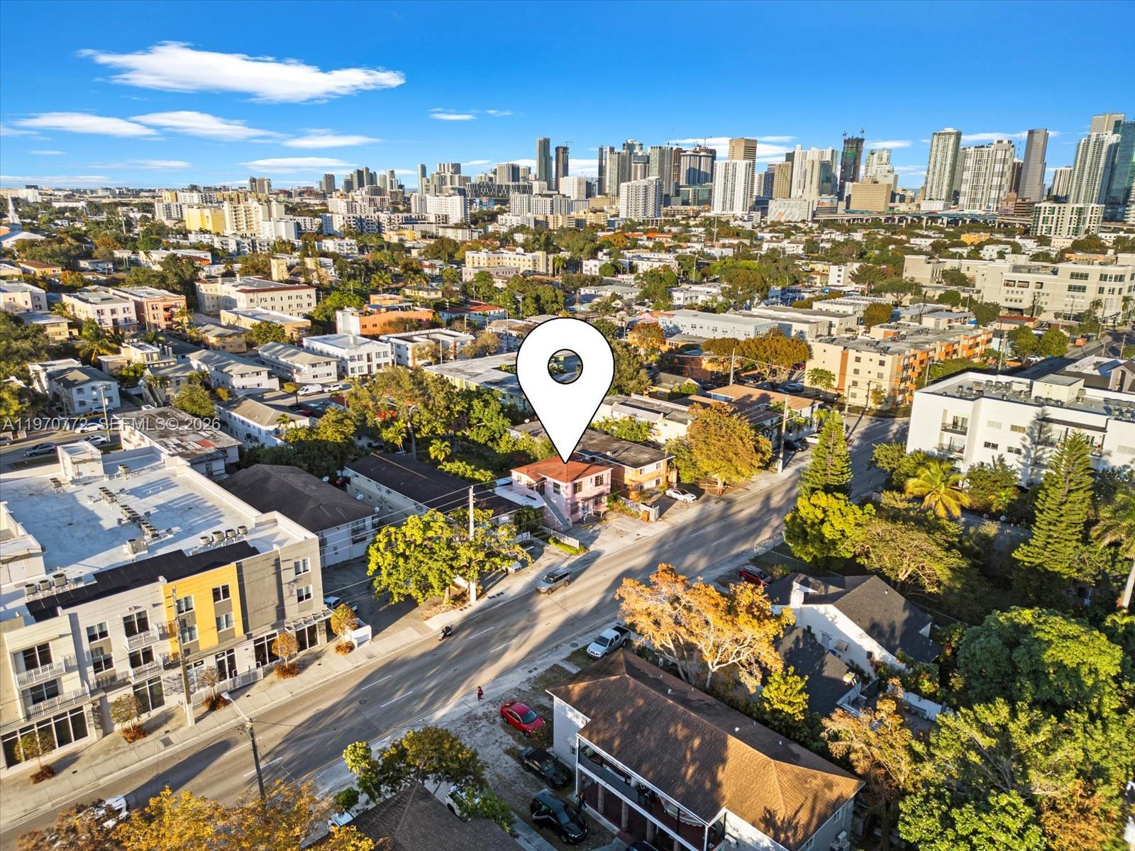 An aerial view shows a pink multi-story building marked by a location pin in a city — 937 SW 7th St, Miami FL 33130, MIAMI, FL