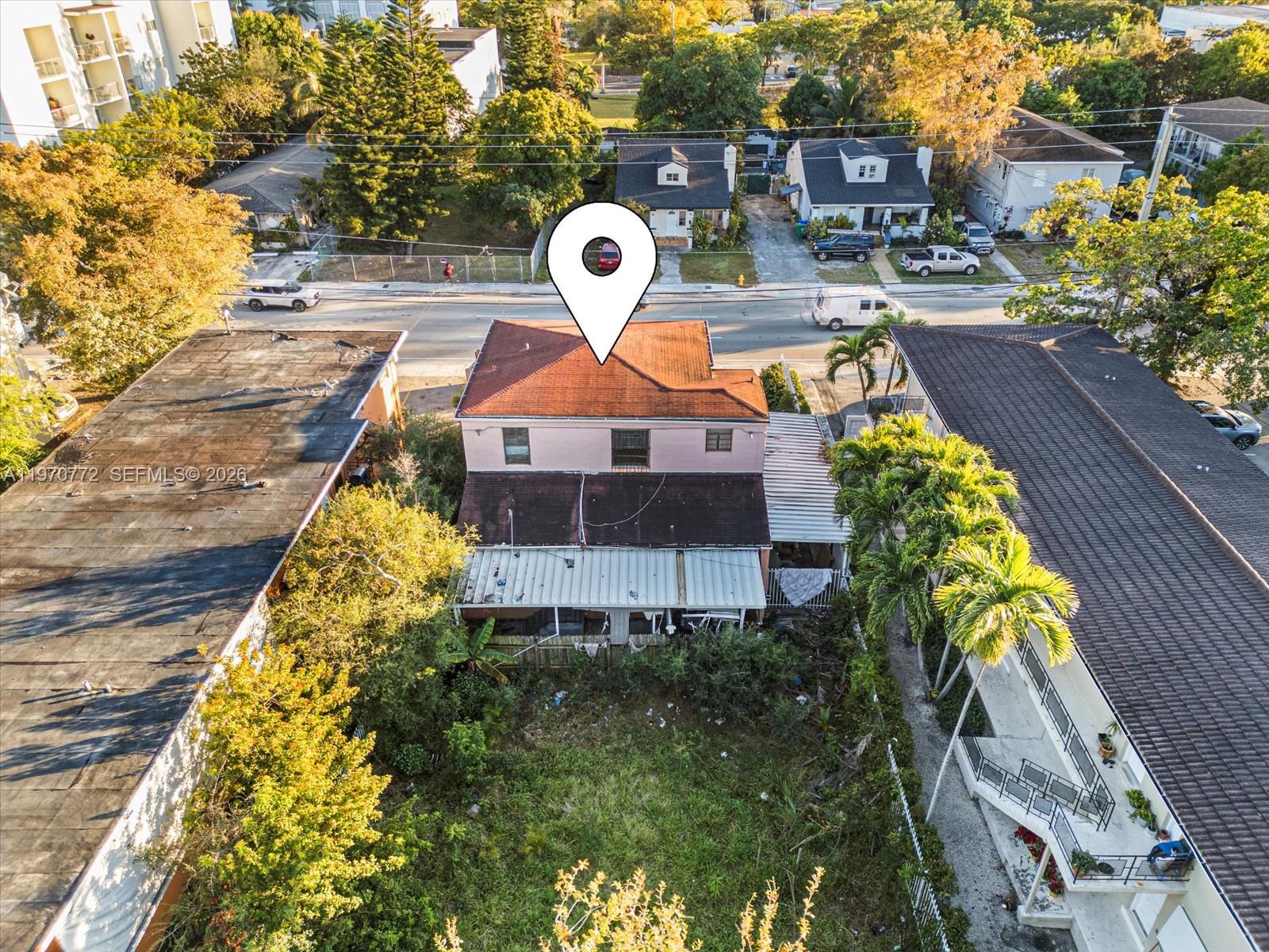 An aerial view shows a two-story house with a red roof and a large backyard — 937 SW 7th St, Miami FL 33130, MIAMI, FL