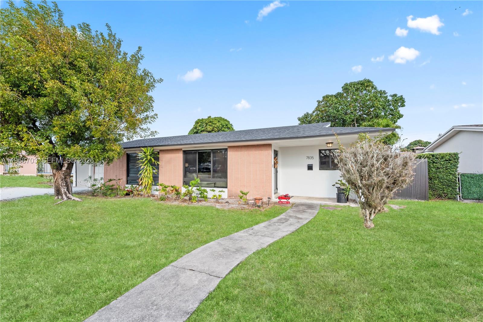 A single-story house with a brick facade, white walls, and a concrete walkway — 7835 W 16th Ct, Hialeah FL 33014, HIALEAH, FL