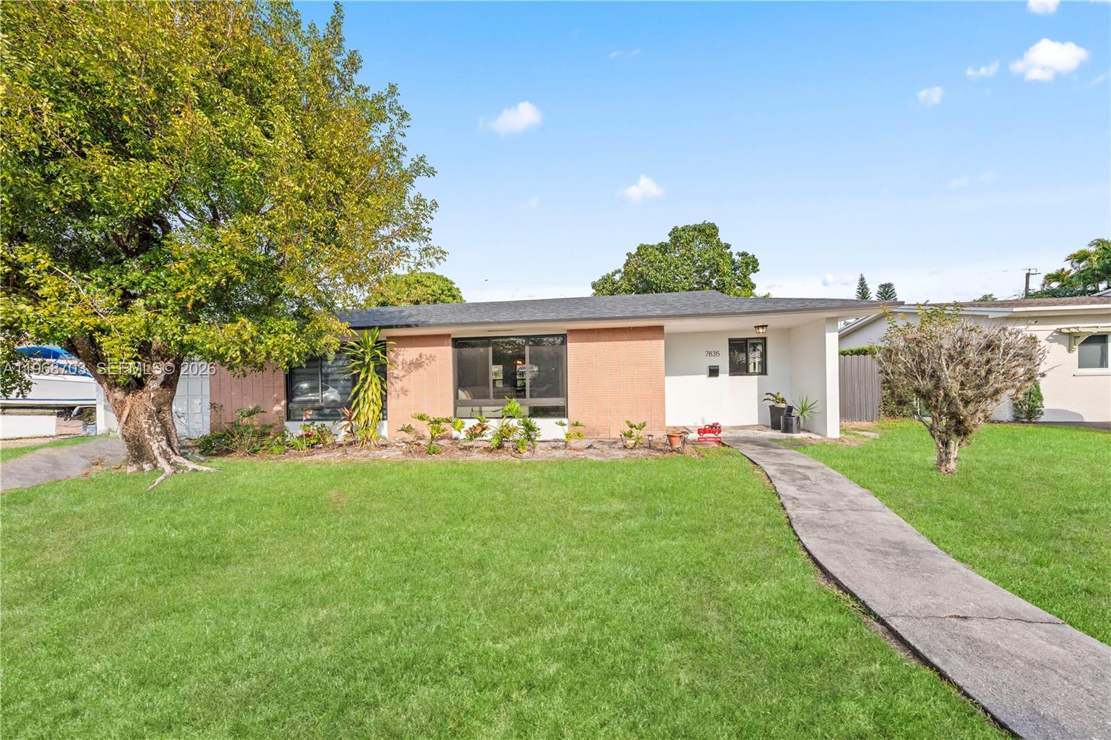 A single-story house with a brick facade, a large tree, and a concrete walkway — 7835 W 16th Ct, Hialeah FL 33014, HIALEAH, FL