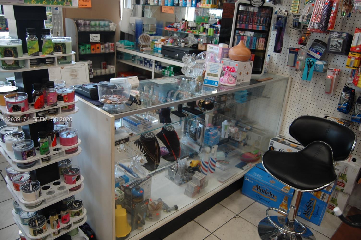 A retail store counter displays various merchandise, including candles, jewelry, and small consumer goods — 1900 e 4th ave, Hialeah FL 33010, HIALEAH, FL