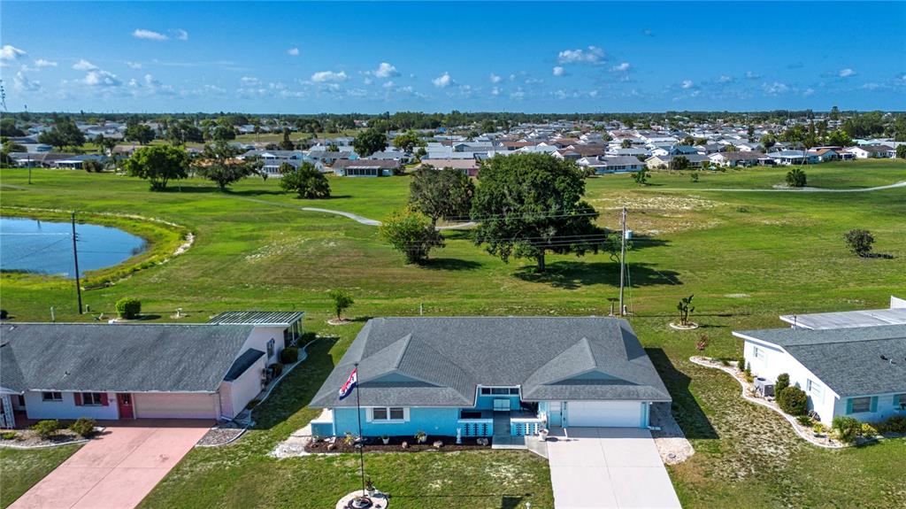 An aerial view shows a light blue house with a gray roof and a driveway — 624 LA JOLLA AVENUE, SUN CITY CENTER, FL