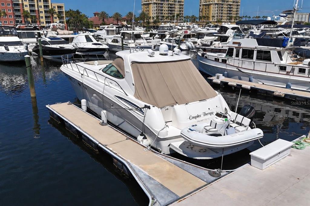 A white motor yacht named Couples Therapy is docked at a marina with other boats — 102 RIVIERA DUNES WAY UNIT S-55, PALMETTO, FL