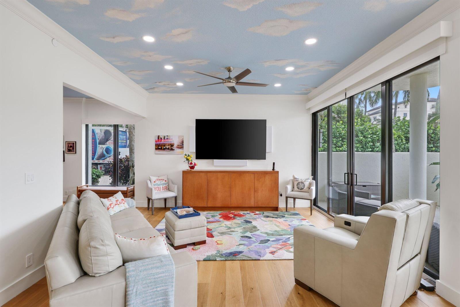 A living room features a cloud-painted ceiling, a floral area rug, and sliding glass doors — 3900 N Ocean Boulevard, Gulf Stream FL 33483, GULF STREAM, FL