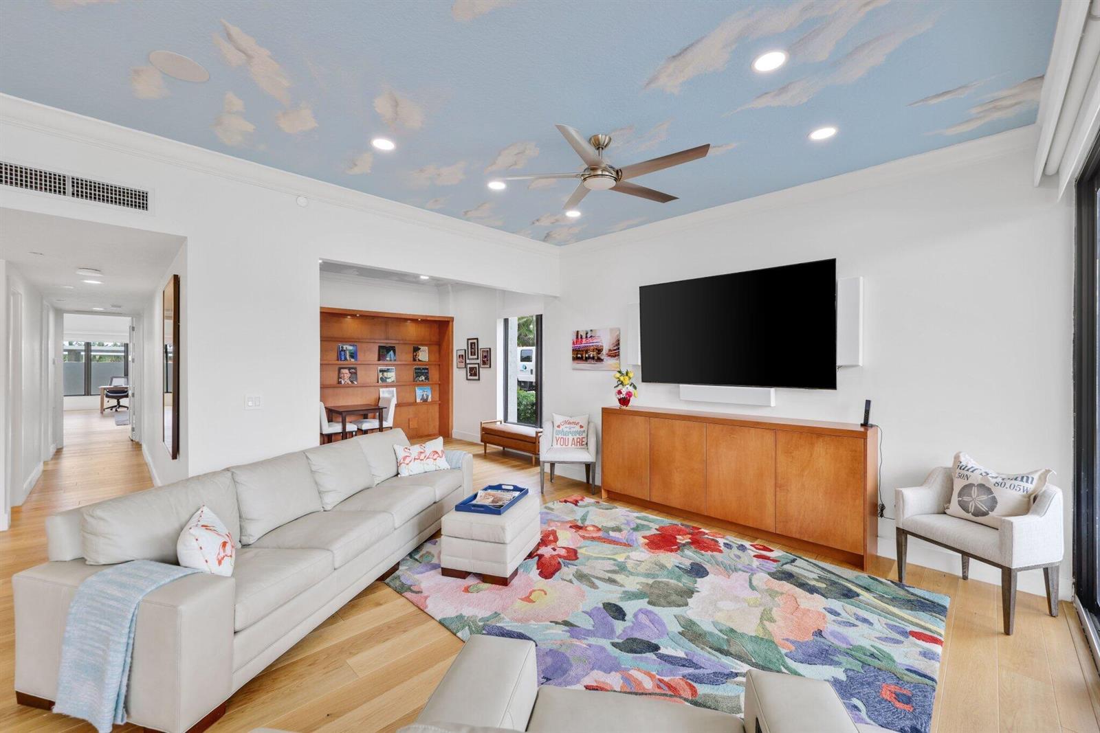A living room features a sky-painted ceiling, a large floral rug, and a wall-mounted television — 3900 N Ocean Boulevard, Gulf Stream FL 33483, GULF STREAM, FL