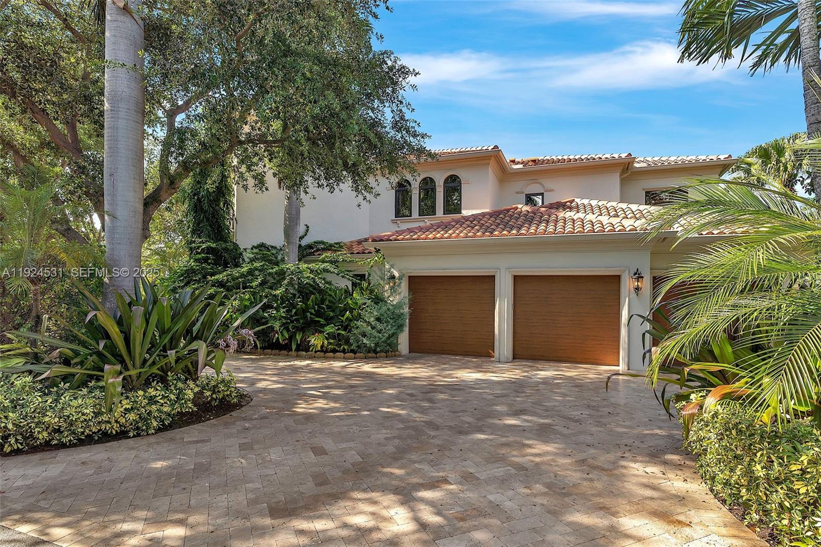 A two-story house with a tiled roof, two garage doors, and a paved driveway — 4008 Sanctuary Ln, Boca Raton FL 33431, BOCA RATON, FL