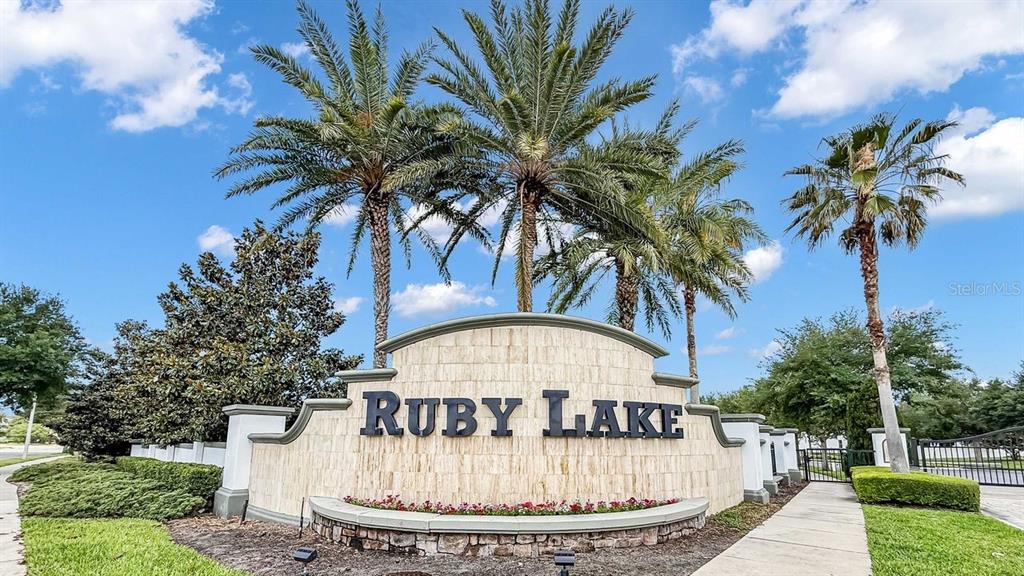 A stone monument sign for Ruby Lake stands in front of palm trees and landscaping — 10944 CITRON OAKS DRIVE, ORLANDO, FL