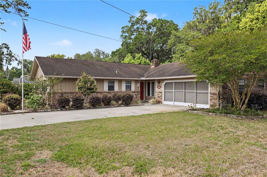 A single-story house with a brick and siding exterior, a garage, and a front lawn — 536 NE 40TH AVENUE, OCALA, FL