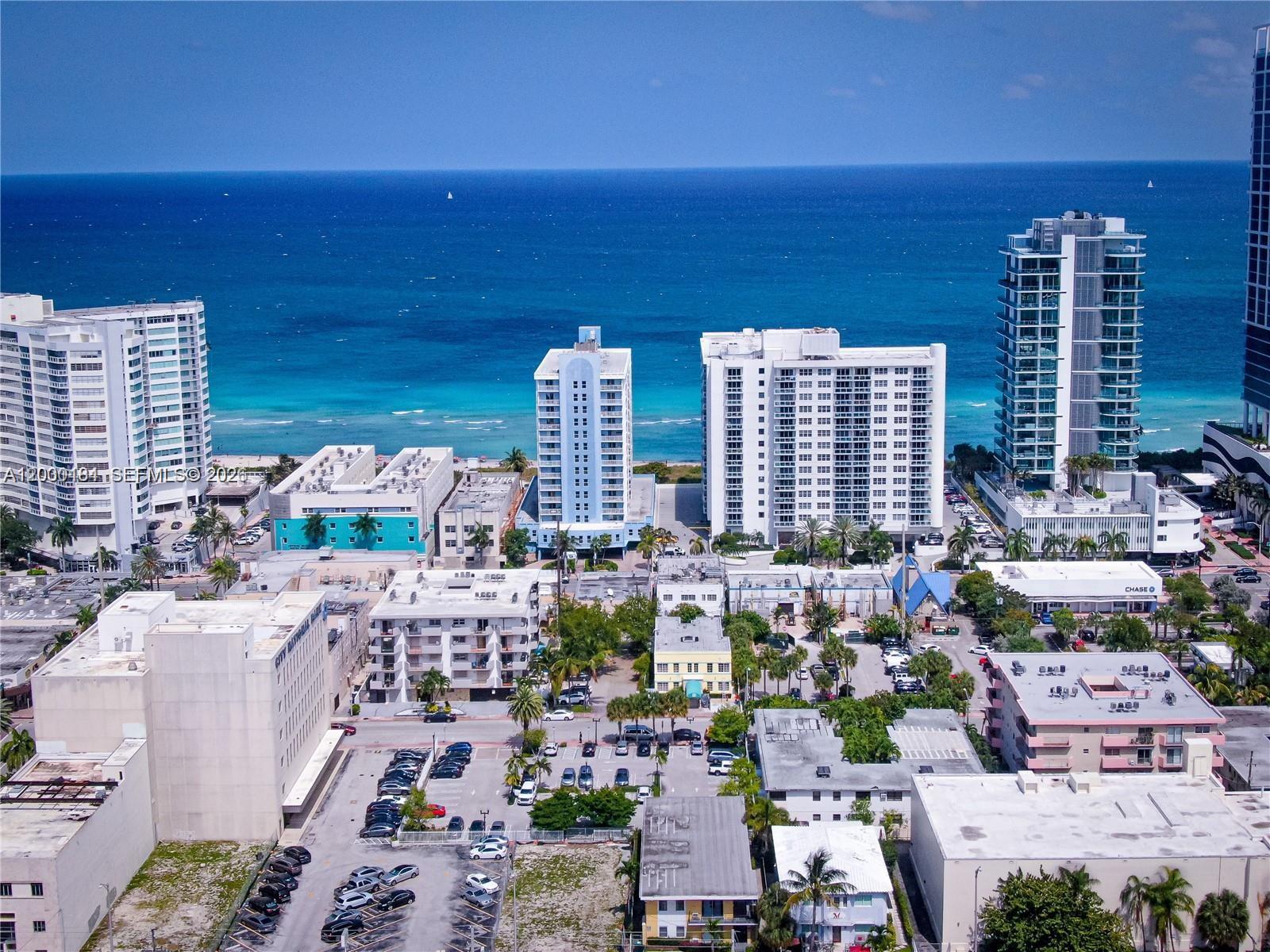 An aerial view of a coastal city featuring high-rise buildings, parking lots, and the ocean — 6945 Abbott Ave, Miami Beach FL 33141, MIAMI BEACH, FL