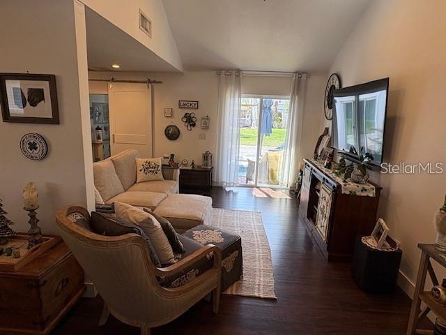 A living room features a sectional sofa, an armchair, a television, and sliding glass doors — 1830 STAUNTON AVENUE, WINTER PARK, FL