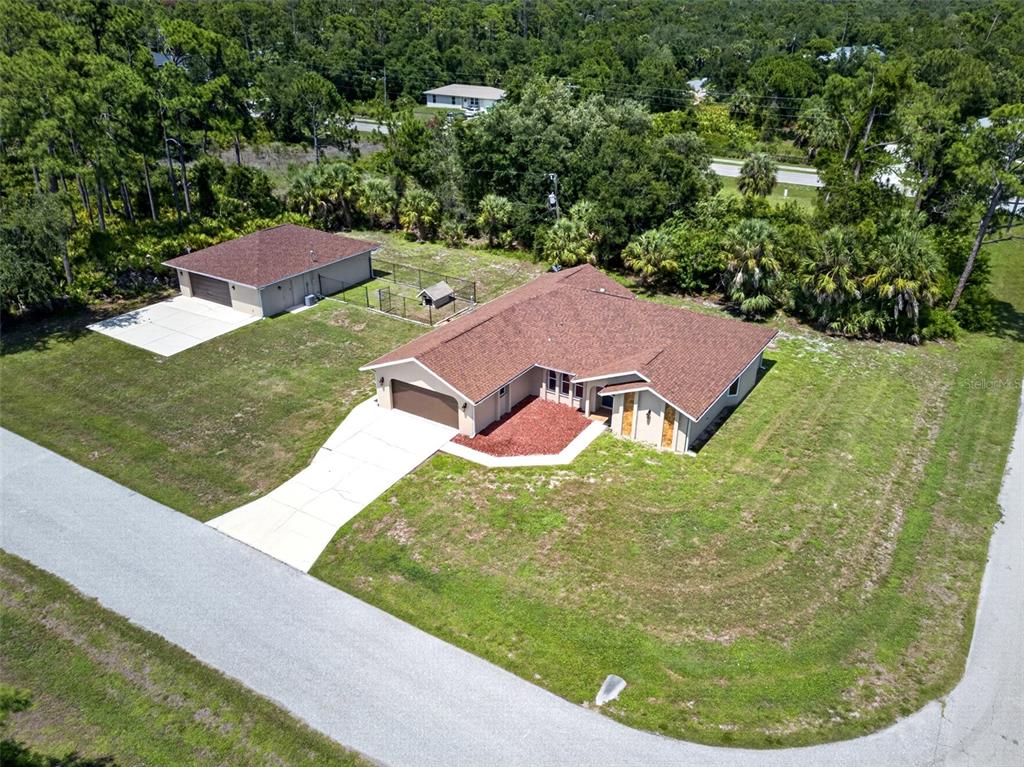 An aerial view shows a house with an attached garage and a separate detached garage — 3318 JERICHO STREET, PORT CHARLOTTE, FL
