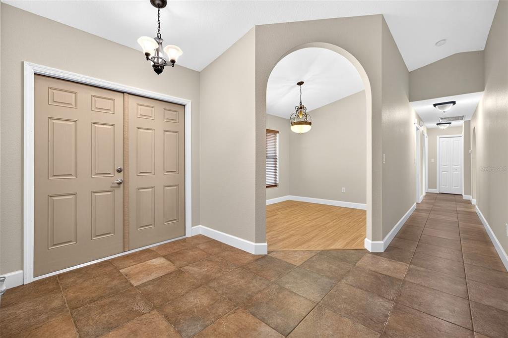 An entryway with tile flooring, a double door, and an arched opening to a room — 3318 JERICHO STREET, PORT CHARLOTTE, FL