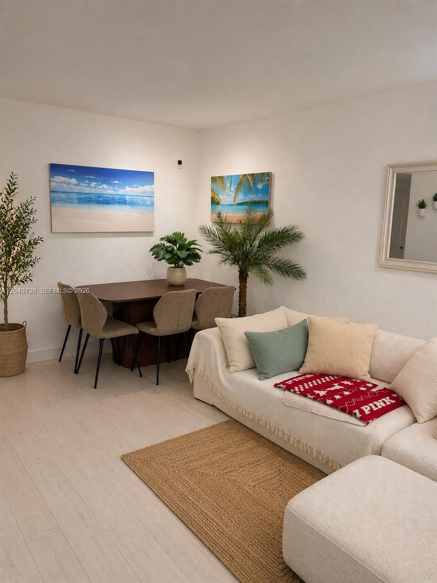 A dining area with a table and chairs sits beside a sofa in this room — 344 Meridian Ave # 2B, Miami Beach FL 33139, MIAMI BEACH, FL