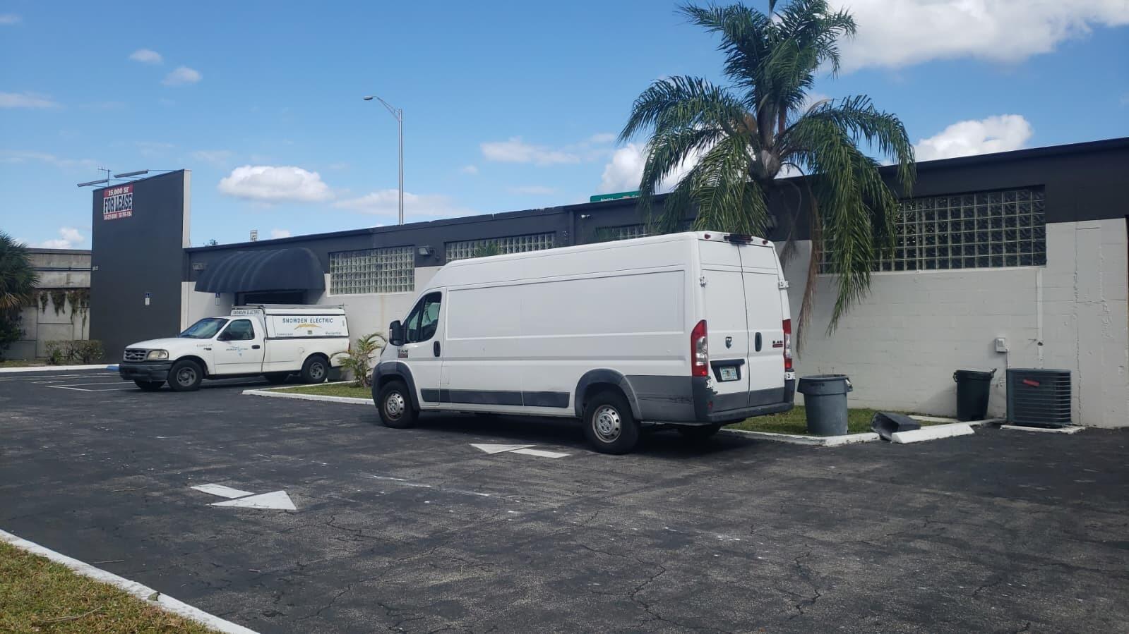 A white cargo van and a service truck are parked in front of a commercial building — 1815 10th Avenue N # C, FL 33461, FL
