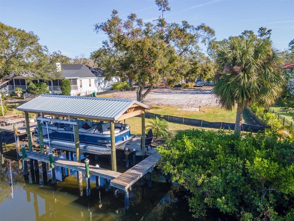 An aerial view shows a boat lift on the water next to a vacant lot — 2609 N DUNDEE STREET, TAMPA, FL