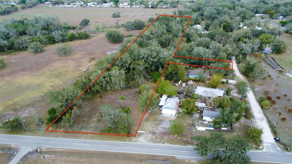 An aerial view shows a large, wooded lot outlined in red next to several houses — DURRANCE STREET SE, ARCADIA, FL