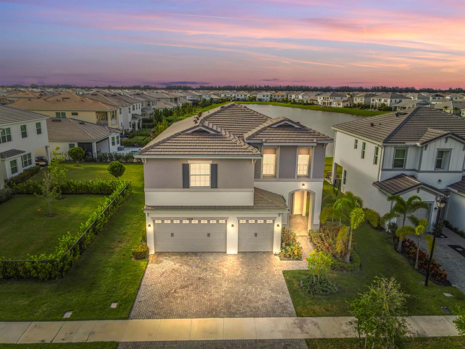 An aerial view of a two-story suburban house with a paved driveway and tile roof — 5236 Liberty Lane, Westlake FL 33470, WESTLAKE, FL