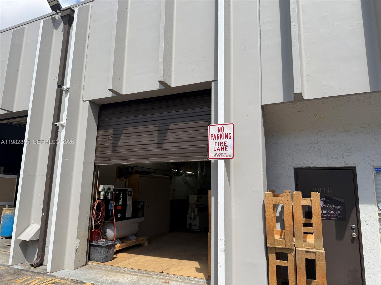 An exterior view shows a warehouse bay door with a fire lane sign and signage — 2016 NW 55th Ave, Margate FL 33063, MARGATE, FL