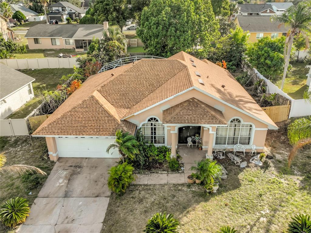 An aerial view of a single-story suburban house with a tan exterior and brown roof — 6832 GOLDENEYE DRIVE, ORLANDO, FL