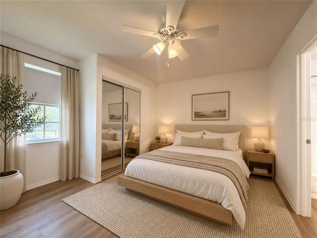 A bedroom features a platform bed, mirrored closet doors, a ceiling fan, and light wood flooring — 3705 SW 27TH STREET UNIT 1225, GAINESVILLE, FL