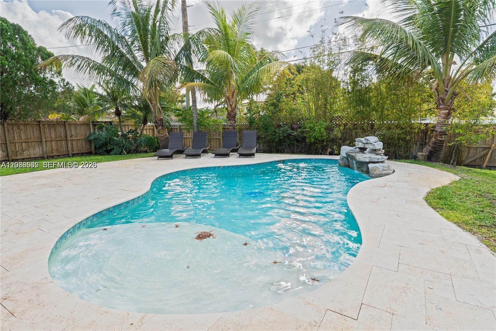A covered patio features stone tile flooring, a wooden pergola ceiling, and a stone-clad bar — 1304 N 40th Ave, Hollywood FL 33021, HOLLYWOOD, FL