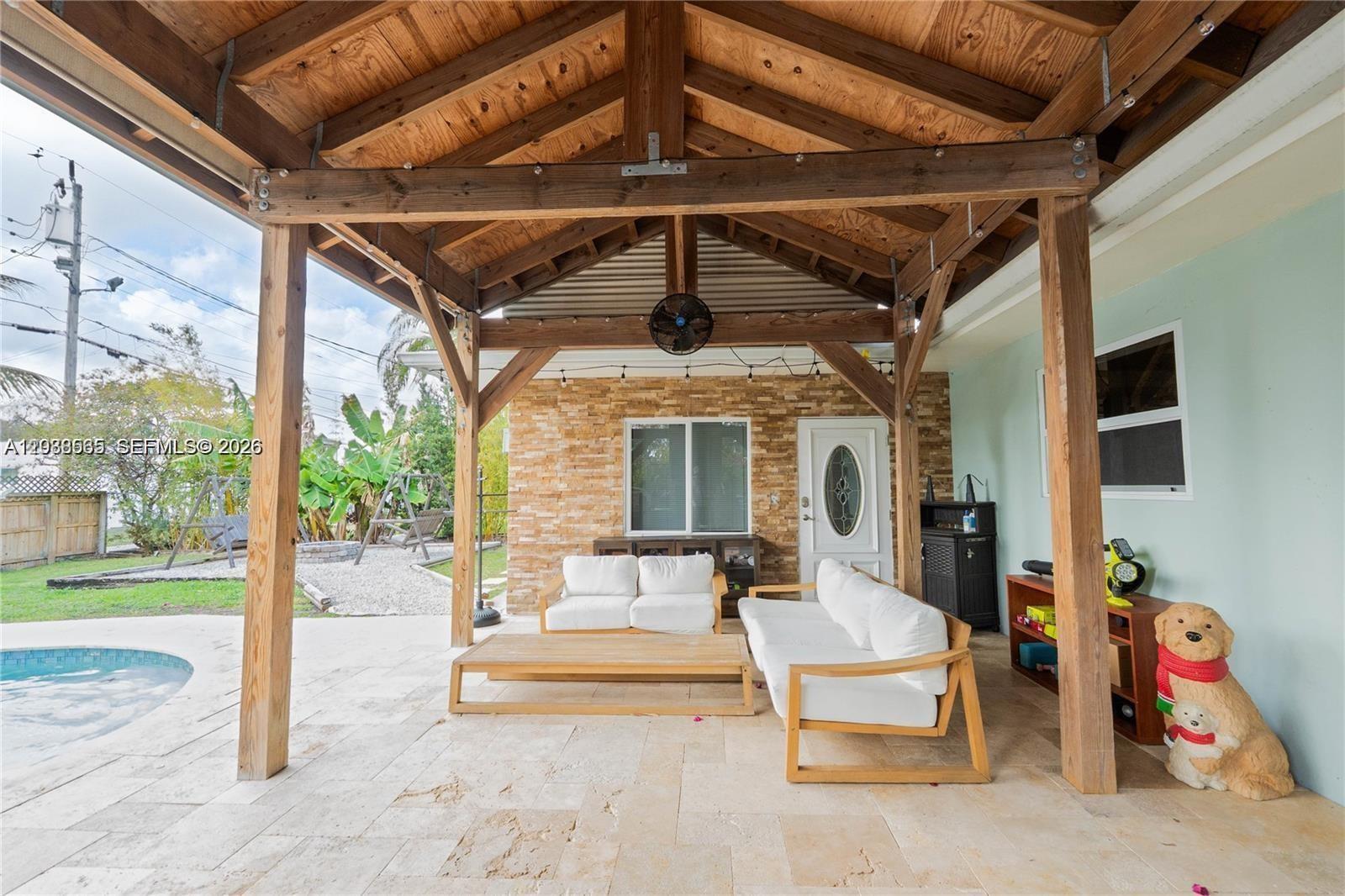 A kitchen features a gray island, wood-look tile flooring, and a built-in window seat — 1304 N 40th Ave, Hollywood FL 33021, HOLLYWOOD, FL