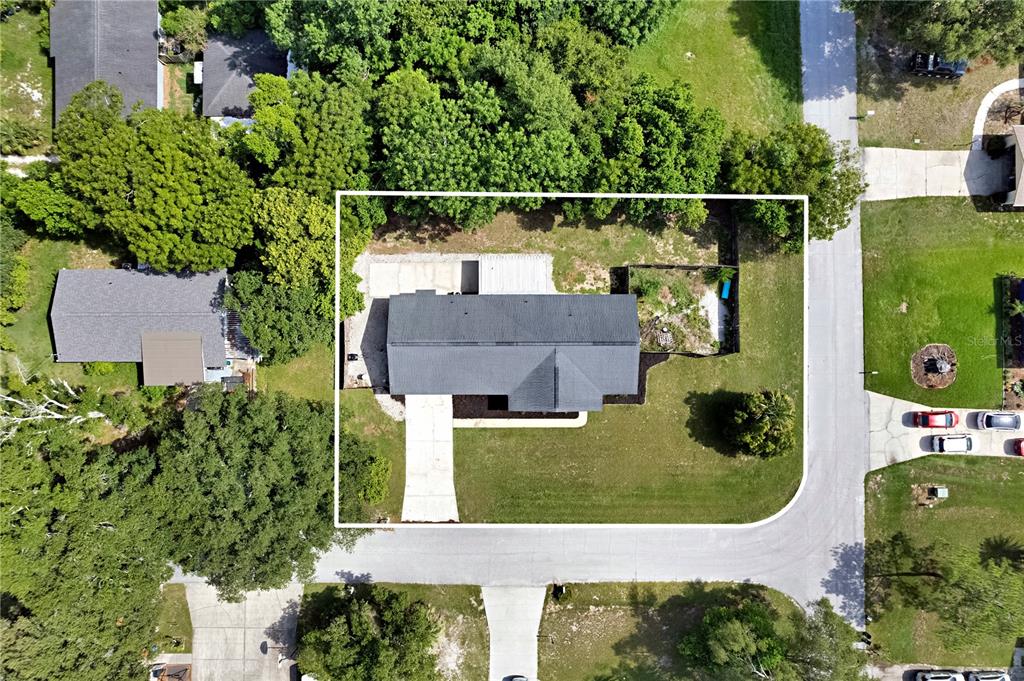 An aerial view shows a single-story house with a dark roof on a corner lot — 1179 FOREST HILLS ROAD, ALTAMONTE SPRINGS, FL