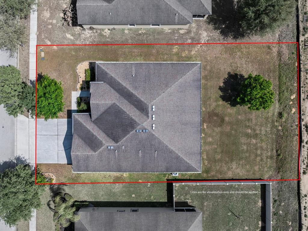 An aerial view shows a house with a gray roof centered on a rectangular lot — 307 GLADESDALE STREET, HAINES CITY, FL