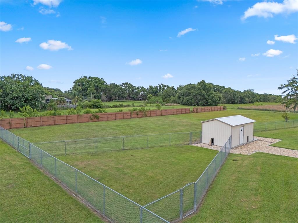 A fenced-in backyard features a small metal shed and a brown privacy fence — LAKE TOHOPEKALIGA BOULEVARD, KISSIMMEE, FL