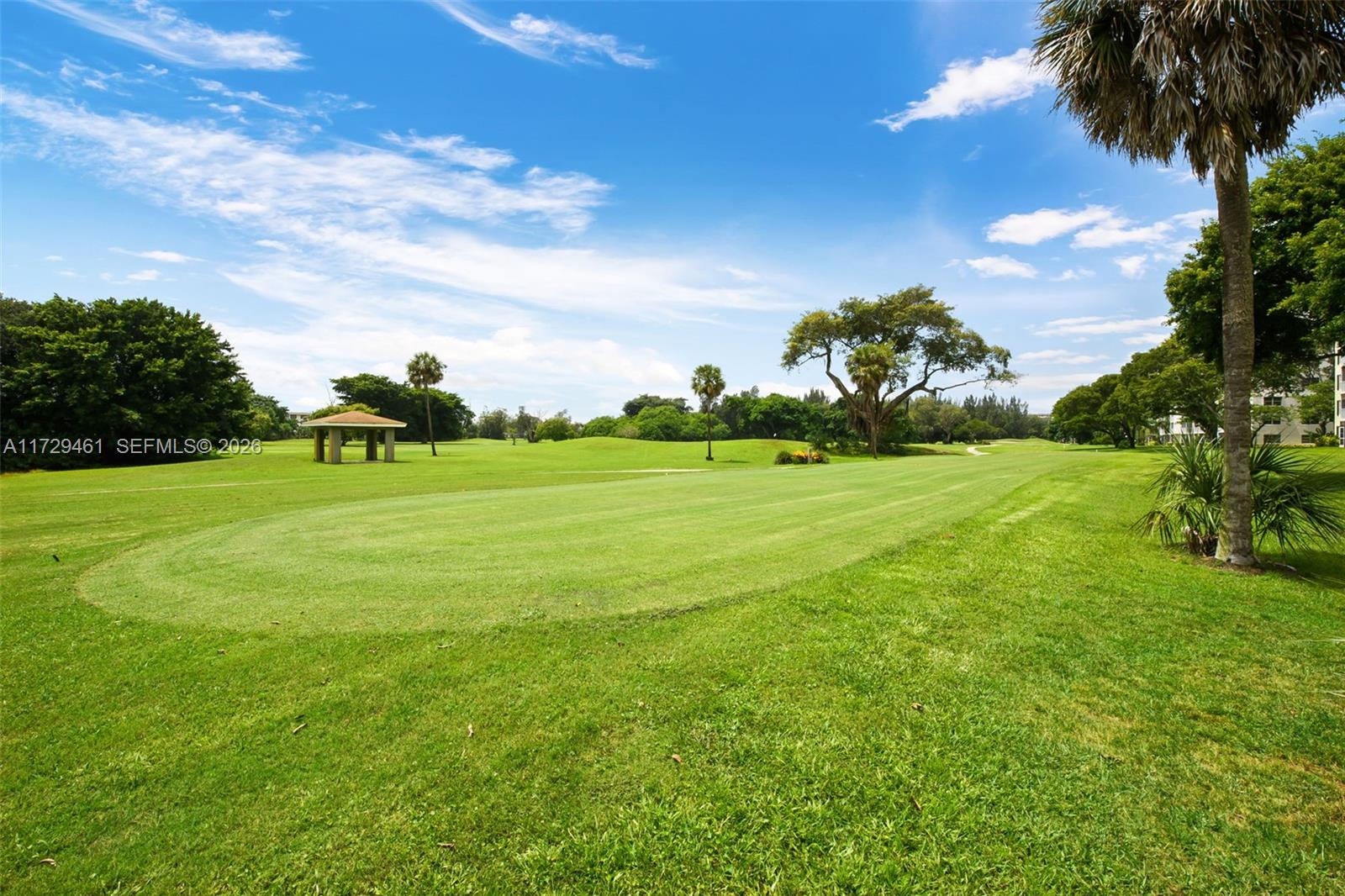 A wide, grassy golf course fairway features a small pavilion and scattered mature trees — 3050 N Palm Aire Dr # 501, Pompano Beach FL 33069, POMPANO BEACH, FL