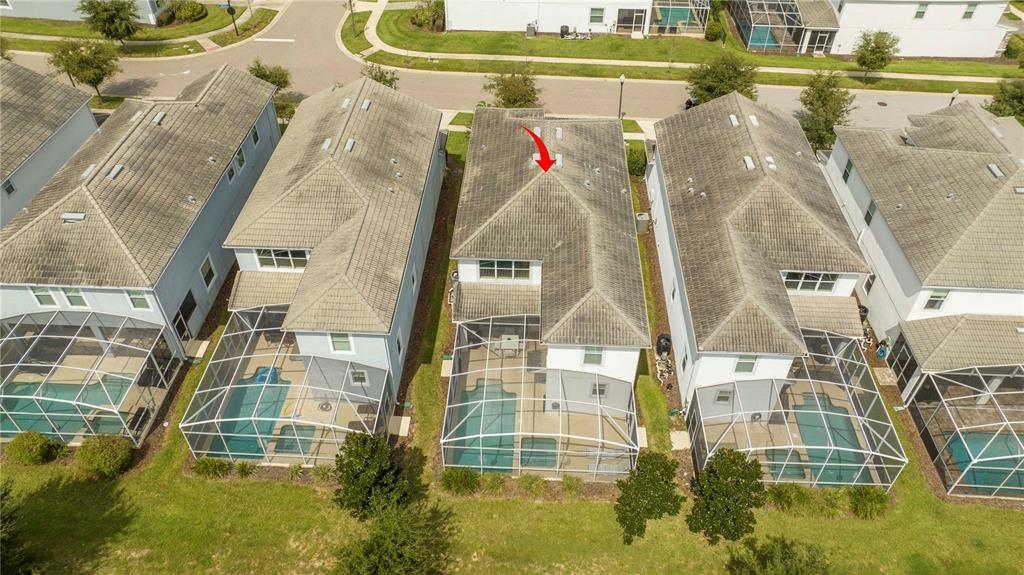 An aerial view shows four suburban houses with screened-in pools and tiled roofs — 1646 MOON VALLEY DRIVE, DAVENPORT, FL