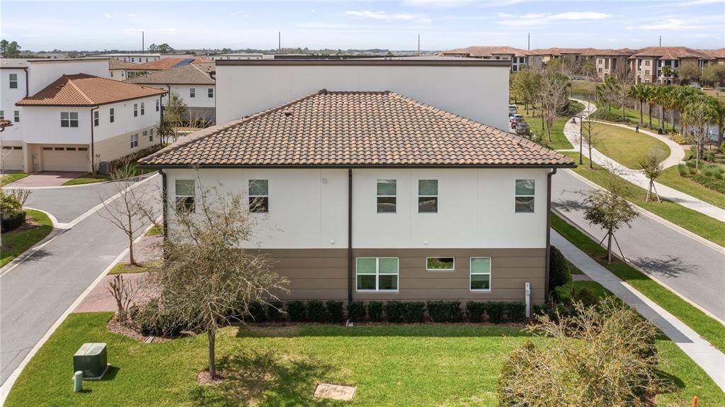 An aerial view of a two-story residential building with a tiled roof and exterior landscaping — 9940 BUCKLOW HILL DRIVE, ORLANDO, FL