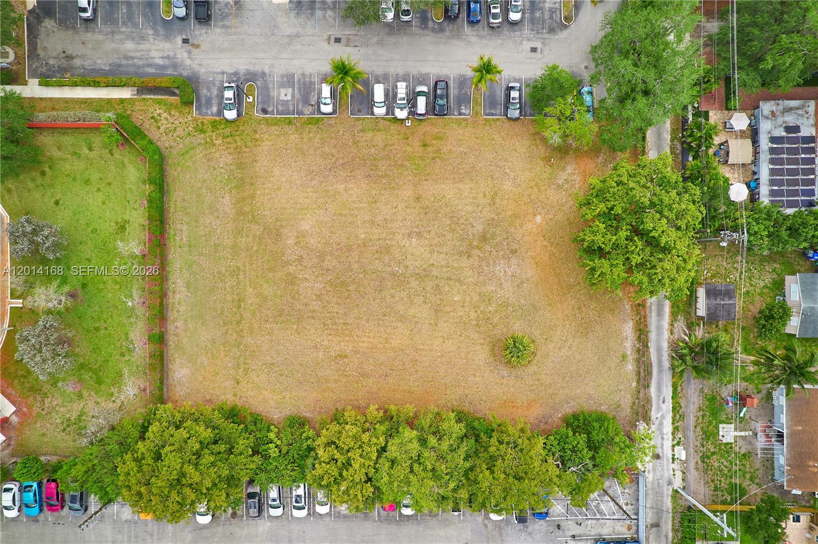 An aerial view shows a rectangular vacant lot surrounded by parking lots and trees — 0 N 61  Avenue, Hollywood FL 33024, HOLLYWOOD, FL