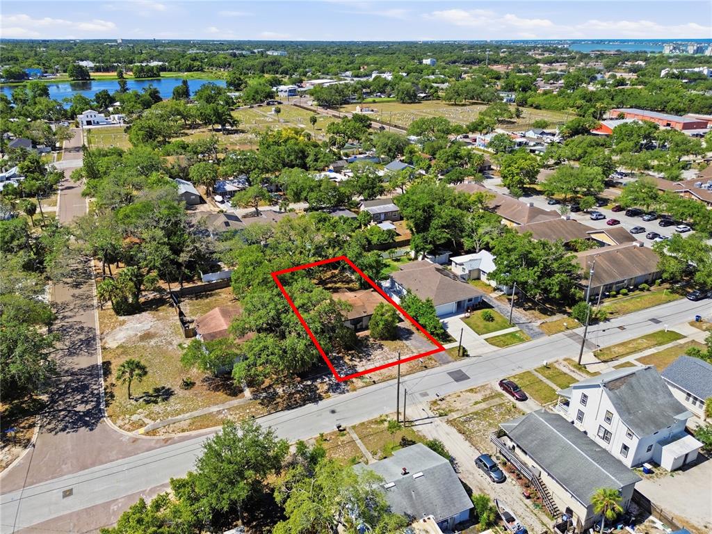 An aerial view shows a single-story house outlined in red on a tree-lined lot — 831 GRAND CENTRAL STREET, CLEARWATER, FL
